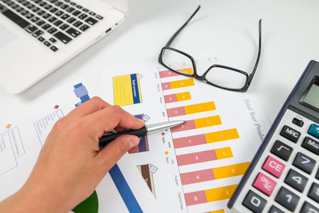 closeup-of-woman-s-hand-pointing-at-chart-compares-statistical-data-examines-values-in-graph-charts-analyzes-patterns-of-trends-taking-notes