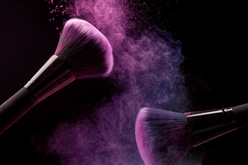 cosmetic-brushes-and-makeup-powder-on-dark-background-min