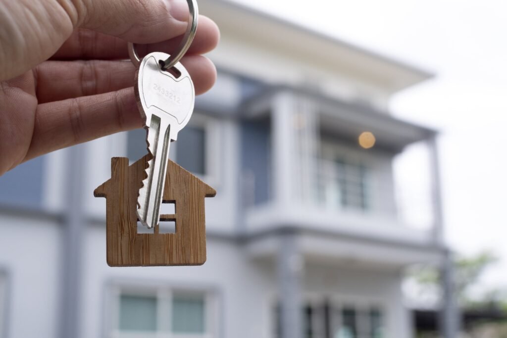 landlord-unlocks-the-house-key-for-new-home-real-estate-agents-sales-agents-min