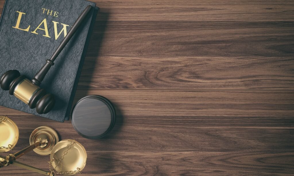 low-key-filter-wooden-judge-s-gavel-on-law-book-and-golden-scale-on-wood-background