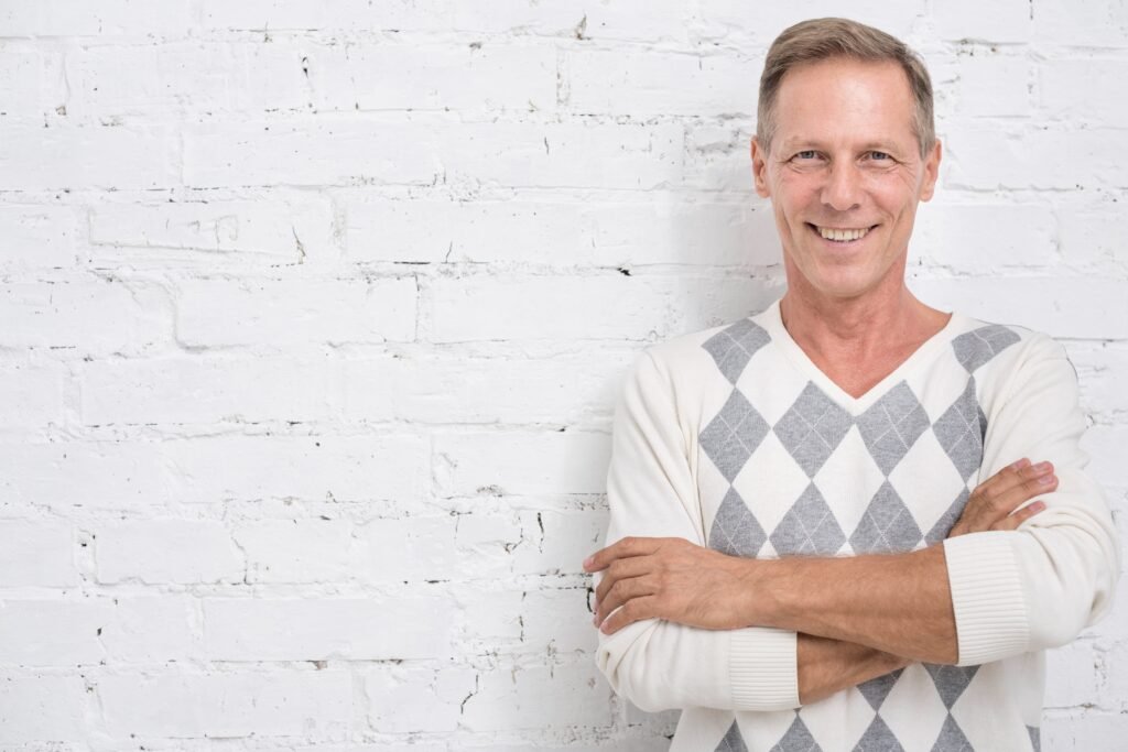 medium-shot-smiley-man-with-brick-background