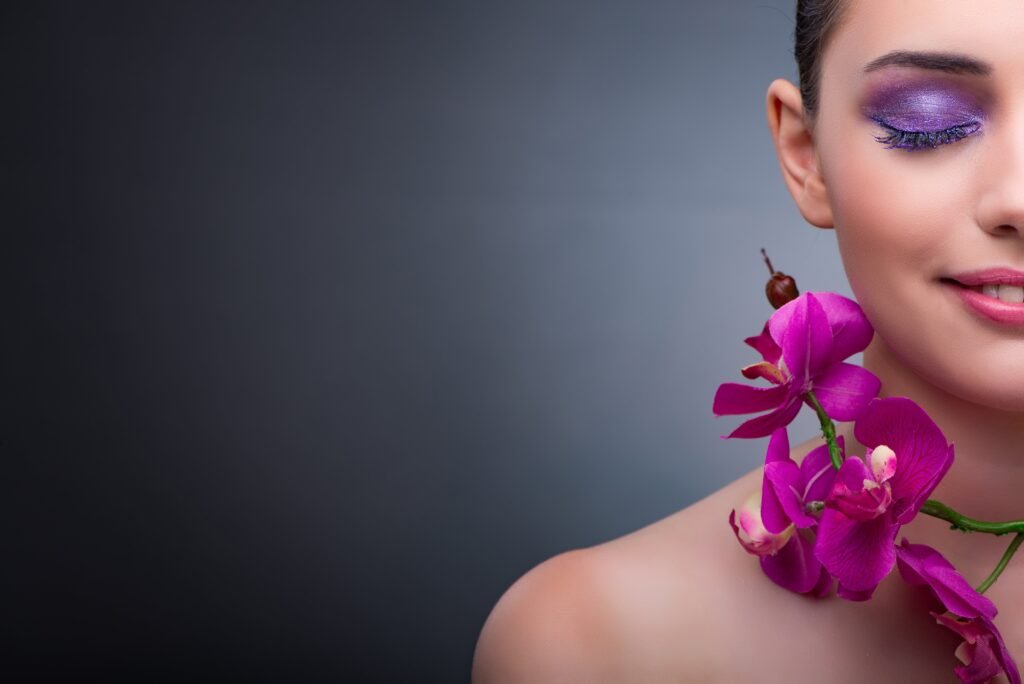 young-woman-in-beauty-concept-with-orchid-flower-min